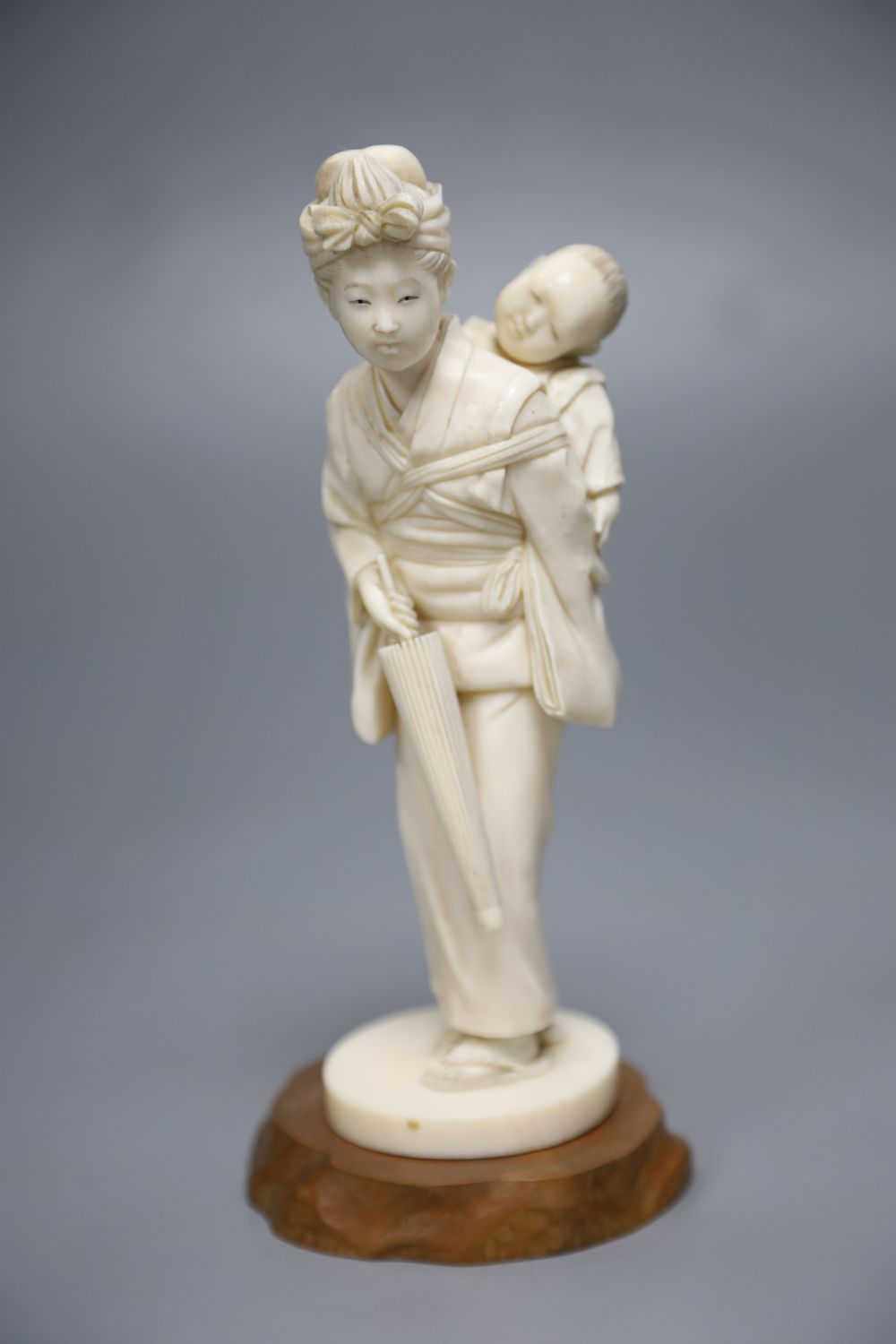 A Japanese carved ivory figure of a geisha and child, height 19cm